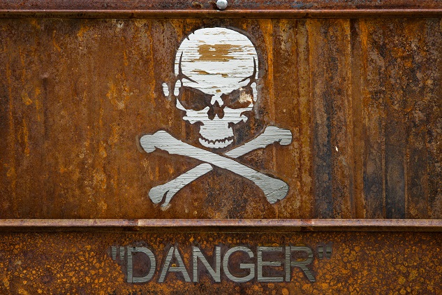 Rusted skull and cross bones danger sign