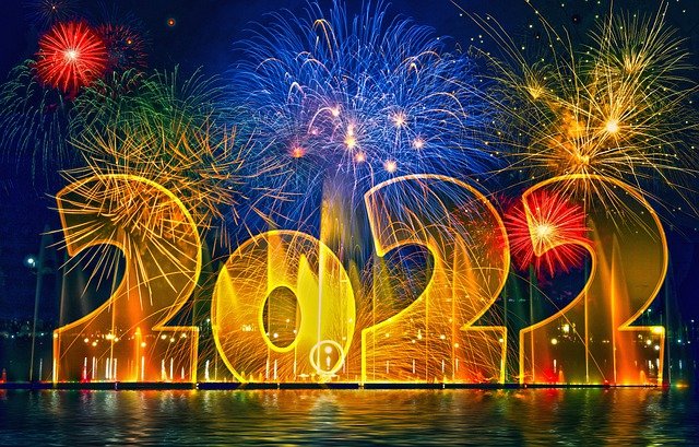 Large sized lettering of the year 2022 with a colorful fireworks background.